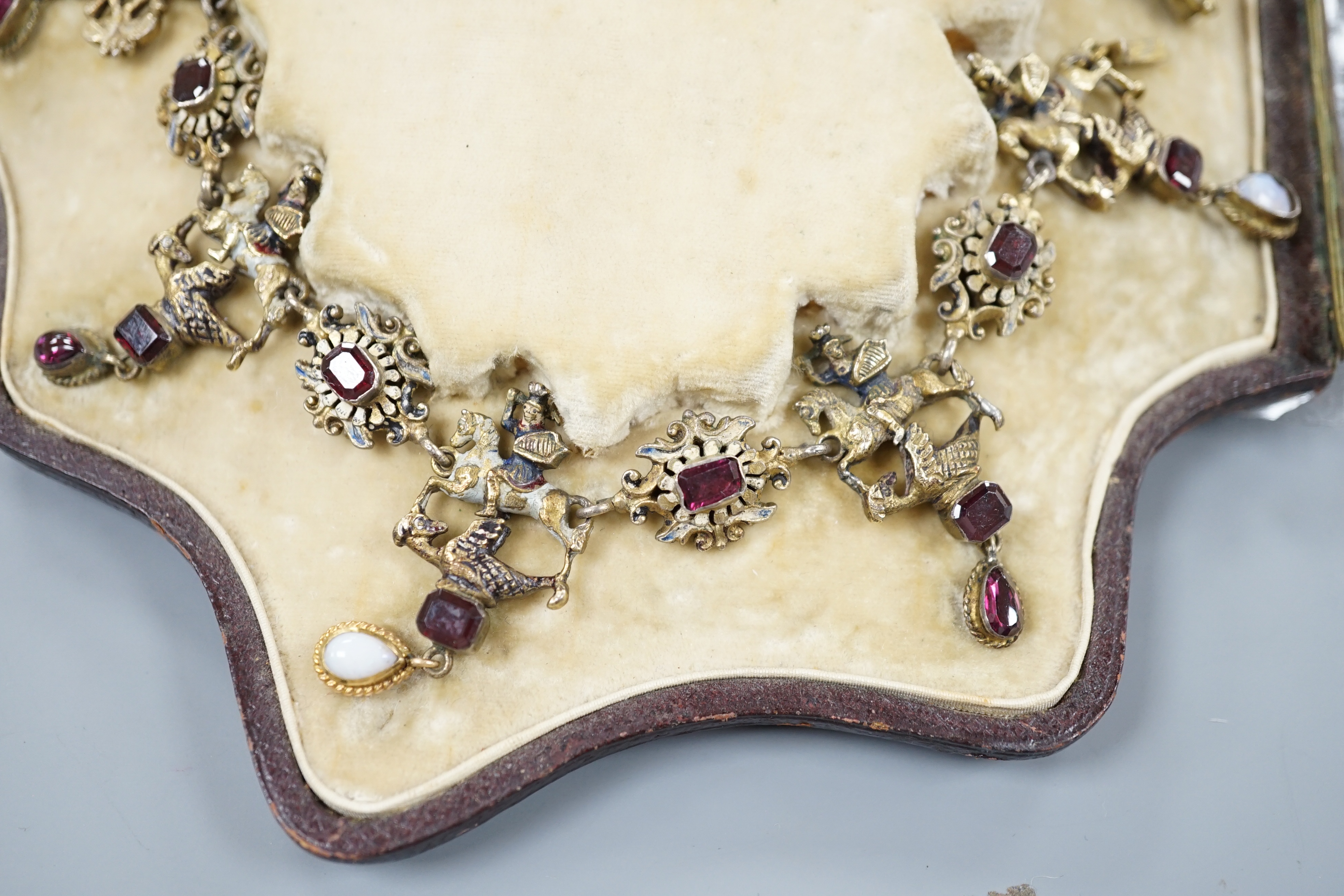 A 19th century Austro-Hungarian? gilt metal, gem, enamel and paste set drop fringe necklace, 36cm, in fitted box.